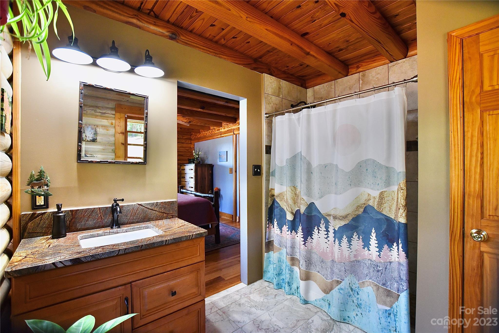 3703 Back Bluff Drive Morganton, NC 28655 - Photo 31 of 48 a bathroom with a granite countertop sink a mirror and shower