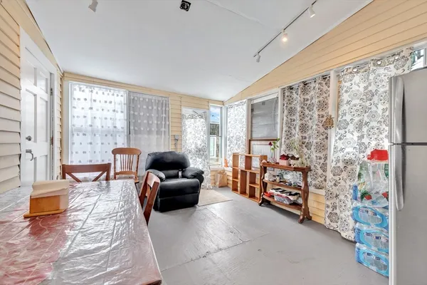 a spacious bedroom with a bed window and couch