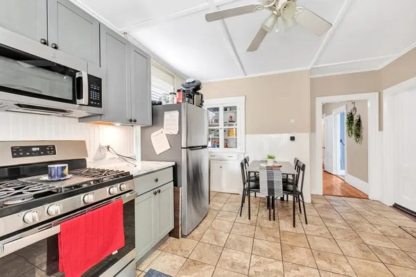 a kitchen with a refrigerator and a stove