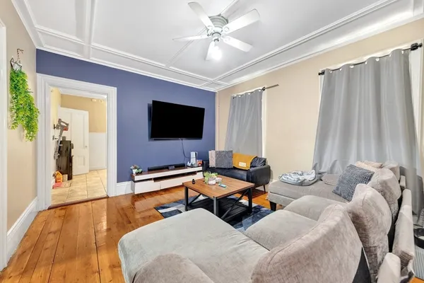 a living room with furniture and a flat screen tv