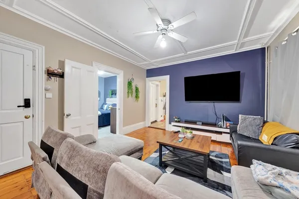 a bedroom with a bed and a dresser with mirror