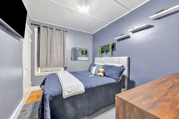 a bedroom with a bed and a flat screen tv