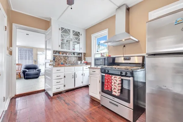 a kitchen with stainless steel appliances granite countertop a stove and a refrigerator