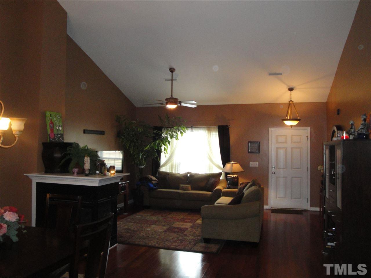 12006 Fox Valley Street Raleigh, NC 27614 - Photo 3 of 25 a living room with furniture and a chandelier