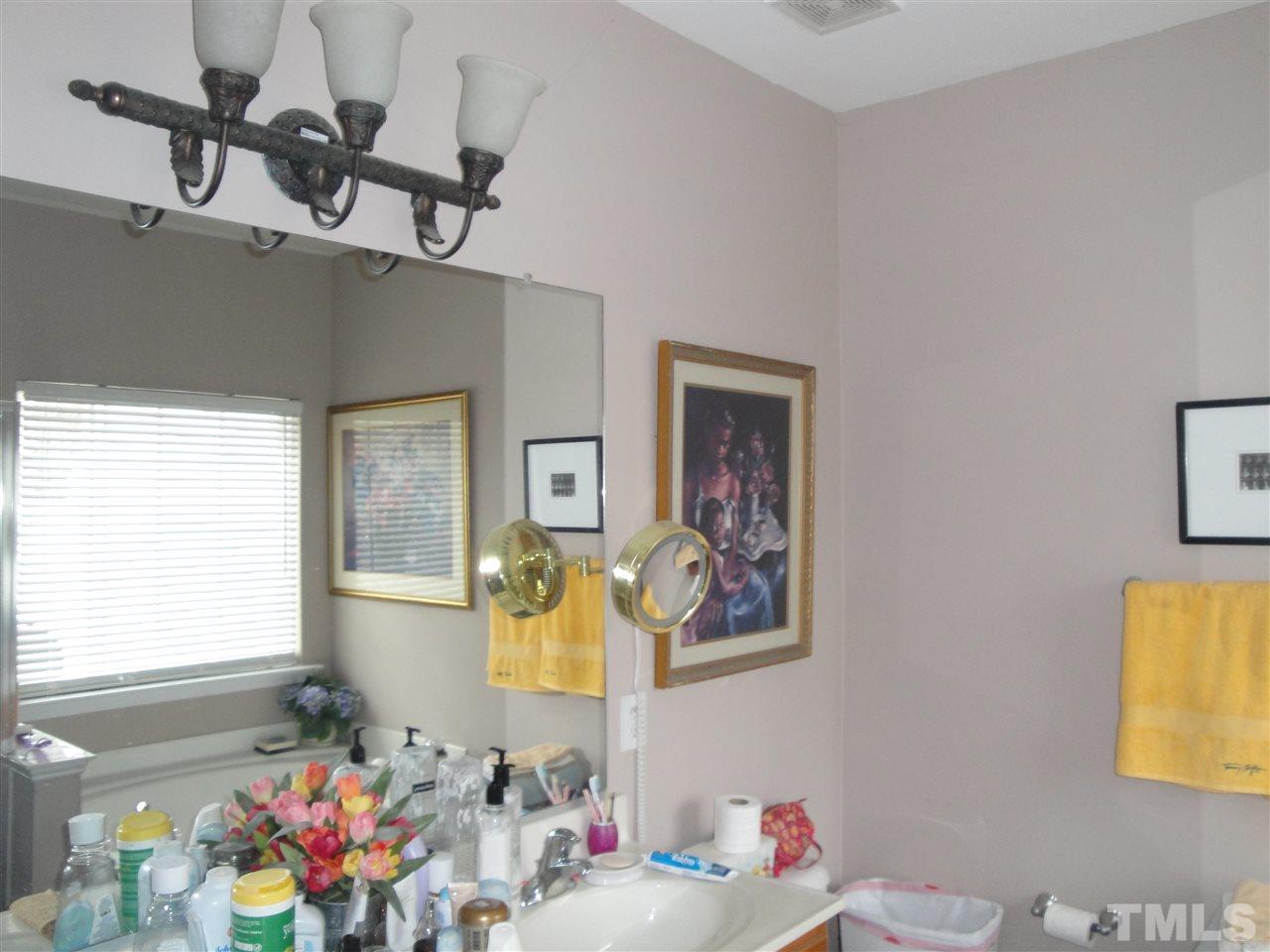 12006 Fox Valley Street Raleigh, NC 27614 - Photo 23 of 25 a bathroom with a sink mirror and vanity