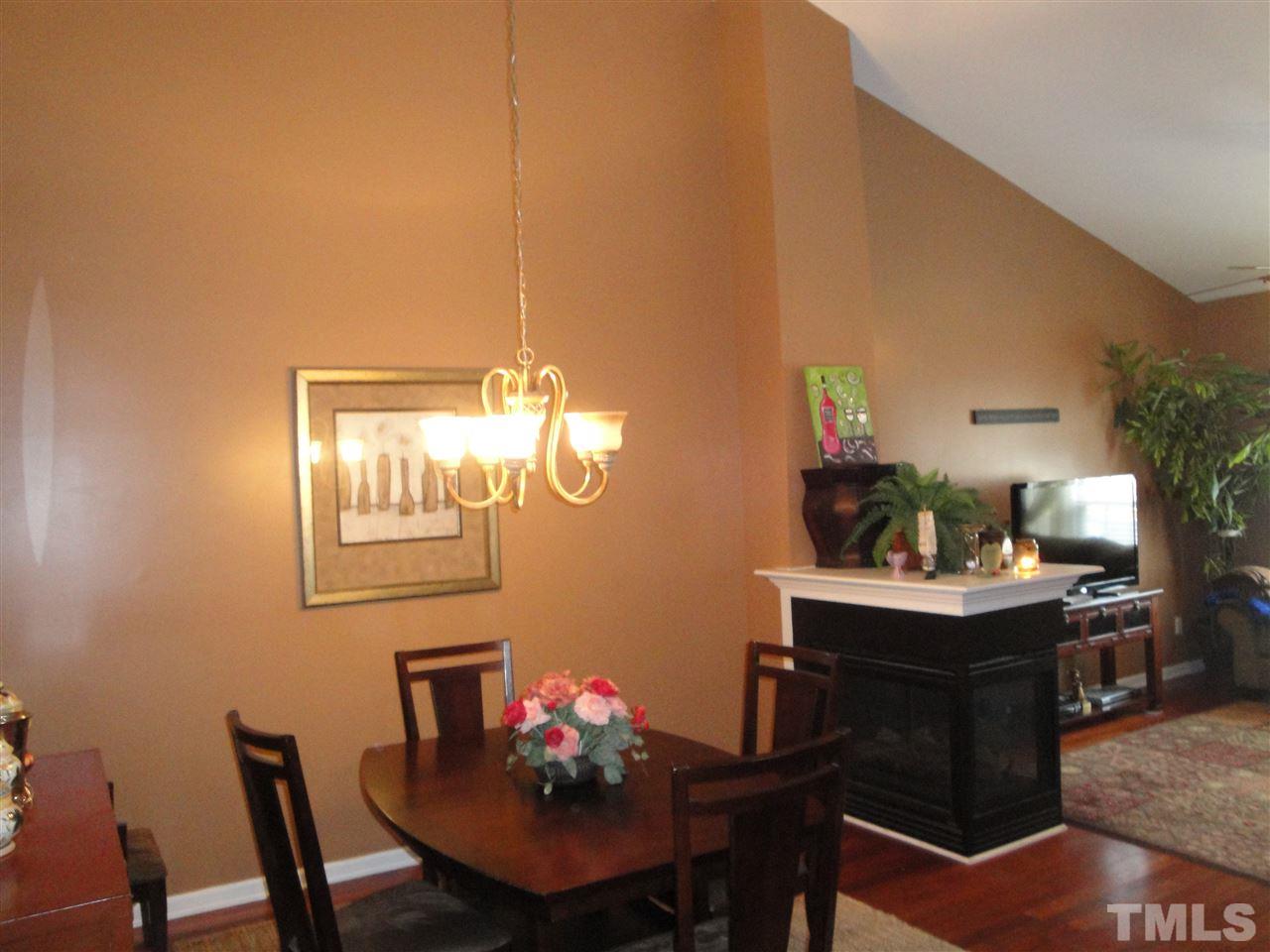 12006 Fox Valley Street Raleigh, NC 27614 - Photo 4 of 25 a view of a dining room with furniture and chandelier