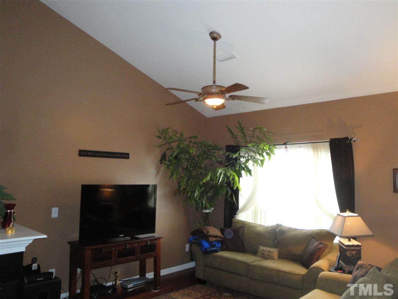 12006 Fox Valley Street Raleigh, NC 27614 - Photo 5 of 25 a living room with furniture and a flat screen tv
