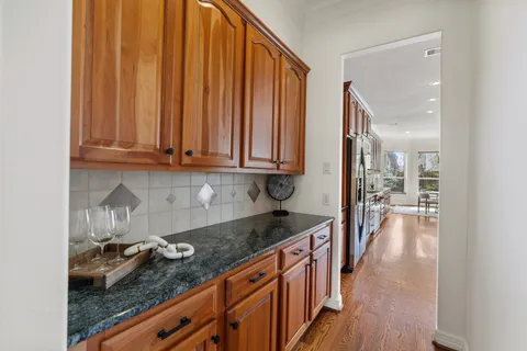 a kitchen with granite countertop a sink stove and cabinets