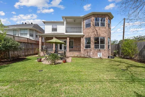 a front view of a house with a garden and yard