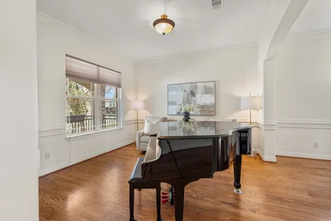 a dining room with wooden floor and a window