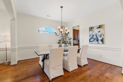 a view of a dining room with furniture wooden floor and chandelier