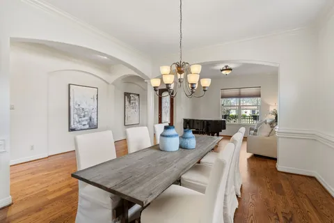 a view of a dining room with furniture wooden floor and chandelier