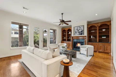 a living room with fireplace furniture and a wooden floor
