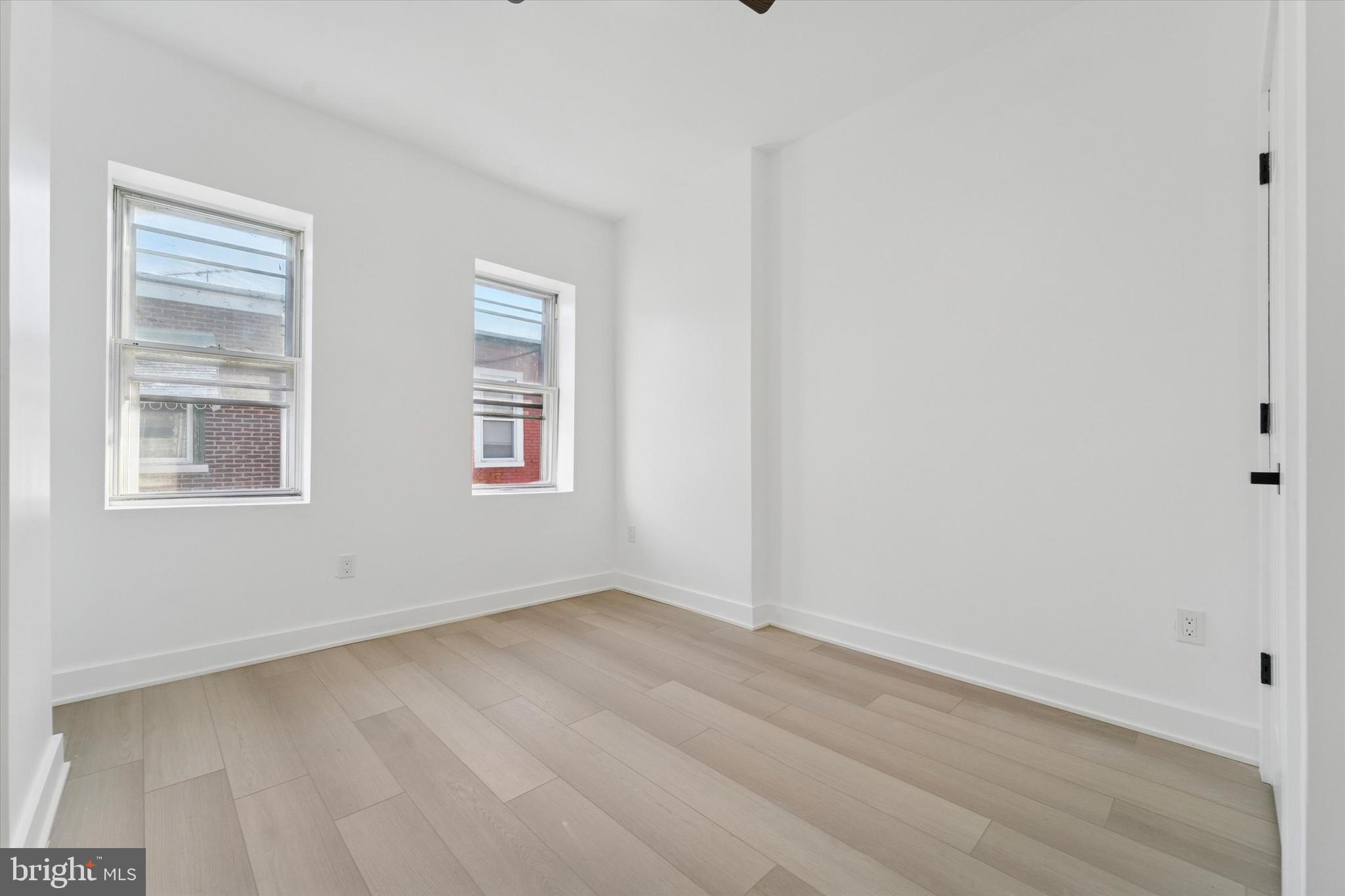 537 North Wanamaker Street Philadelphia, PA 19131 - Photo 18 of 37 a view of an empty room with wooden floor and a window