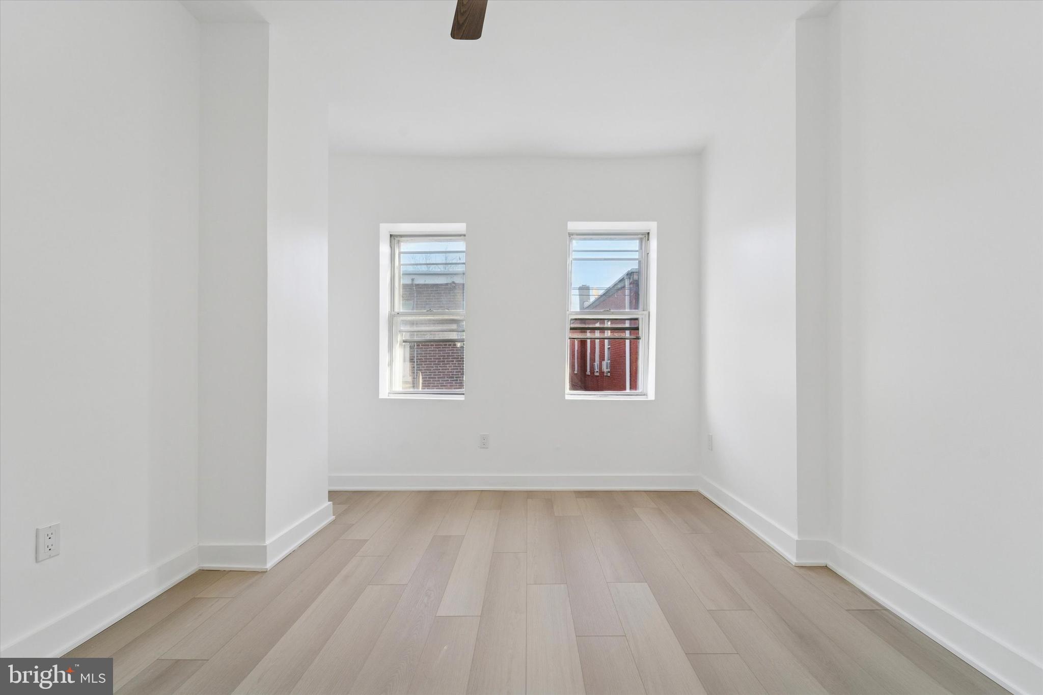 537 North Wanamaker Street Philadelphia, PA 19131 - Photo 22 of 37 an empty room with wooden floor and windows