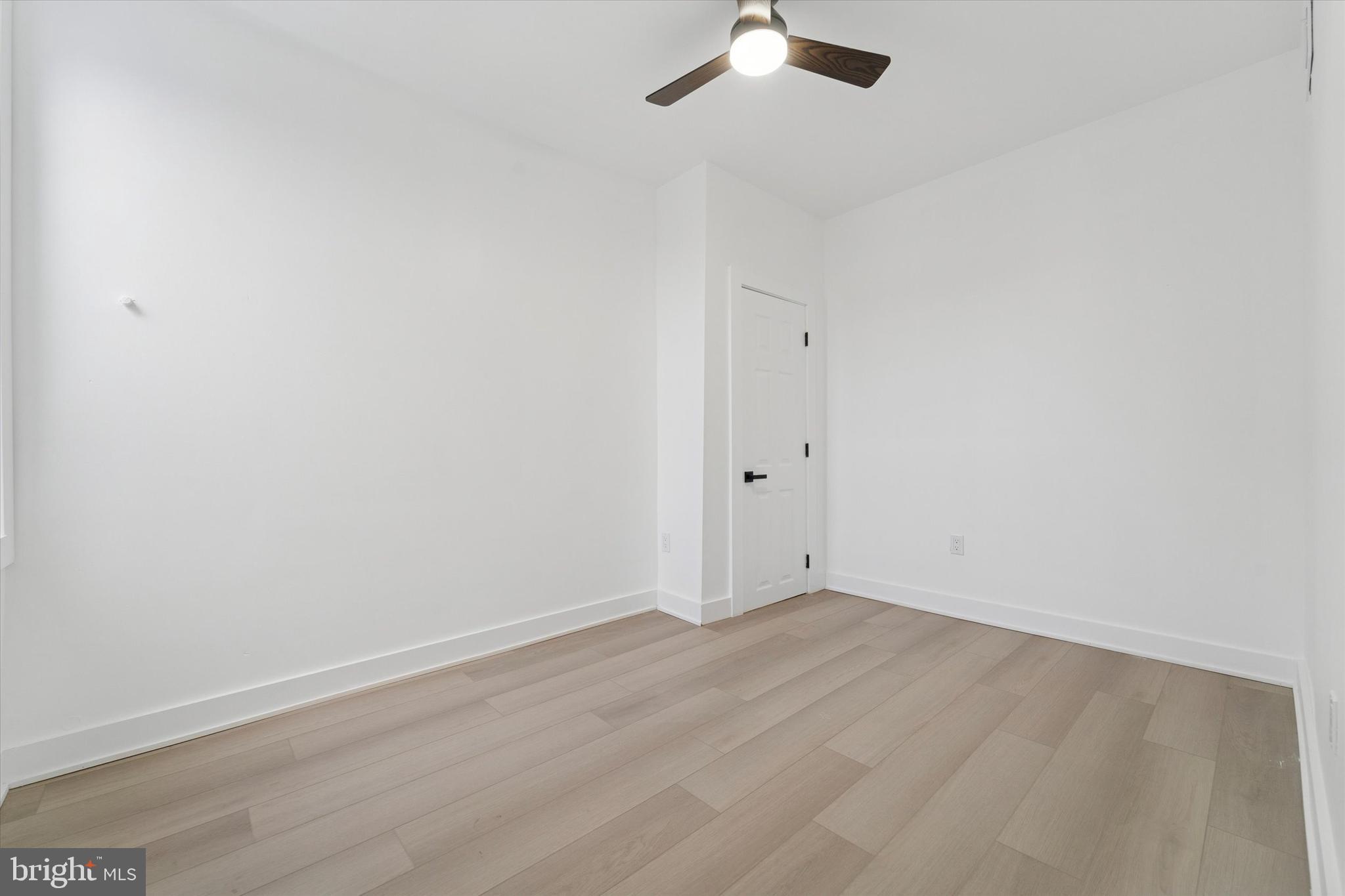 537 North Wanamaker Street Philadelphia, PA 19131 - Photo 23 of 37 an empty room with a chandelier fan and wooden floor
