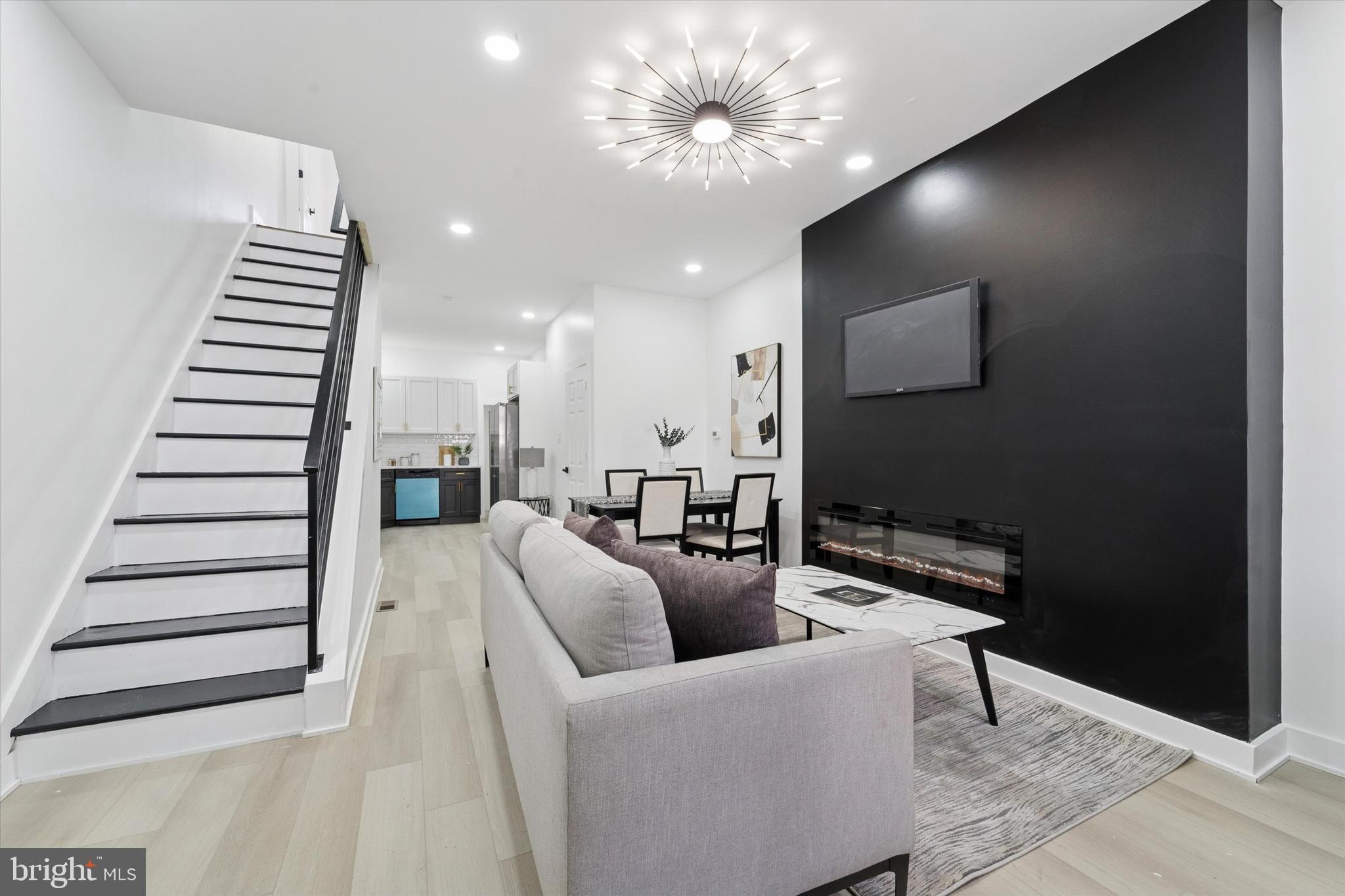 537 North Wanamaker Street Philadelphia, PA 19131 - Photo 5 of 37 a living room with furniture and a chandelier