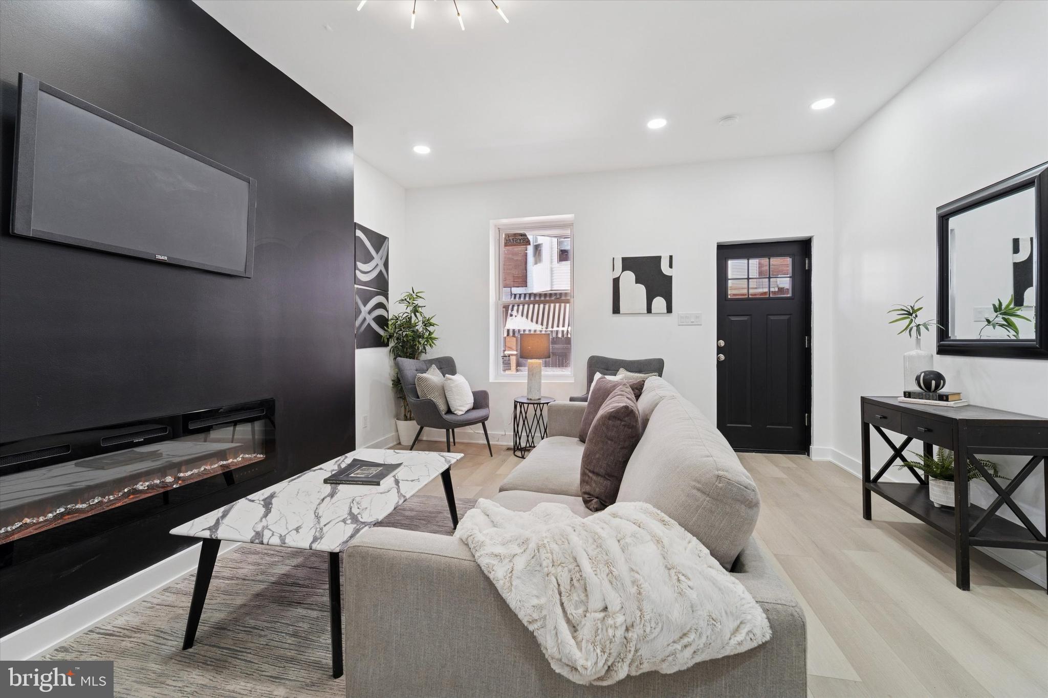 537 North Wanamaker Street Philadelphia, PA 19131 - Photo 8 of 37 a living room with furniture potted plant and a table