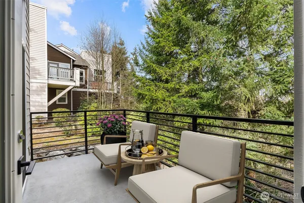 a balcony with table and chairs