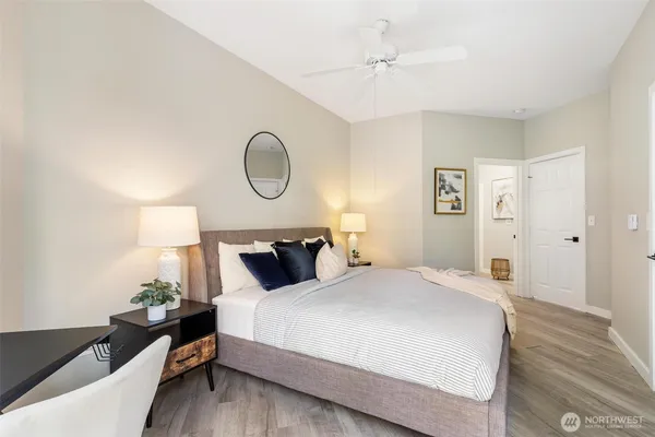 a bedroom with a bed and a lamp