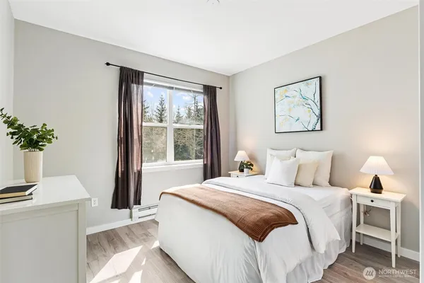 a bedroom with a large bed and a window