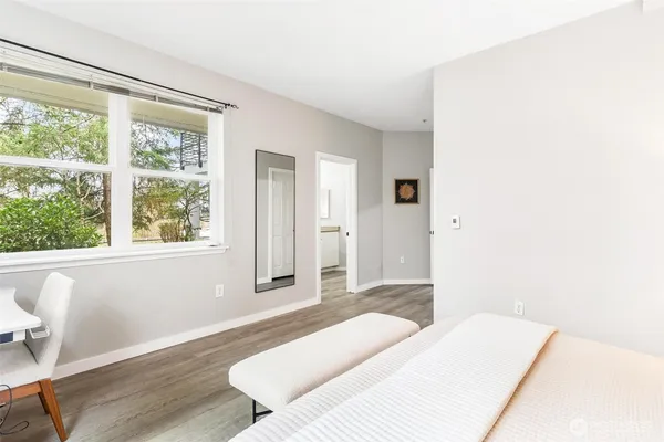 a bedroom with a bed and a large window