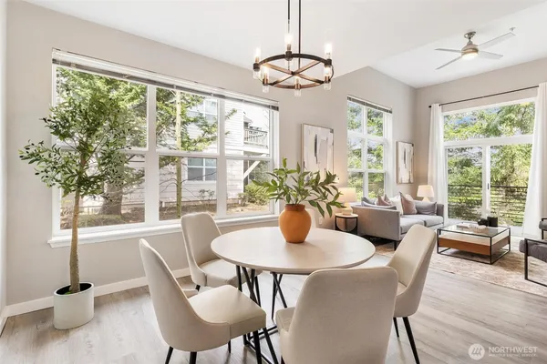 a dining room with furniture a chandelier and wooden floor
