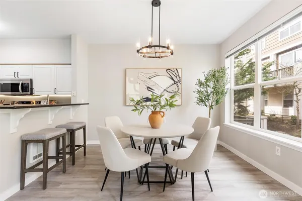 a view of a dining room with furniture window and wooden floor
