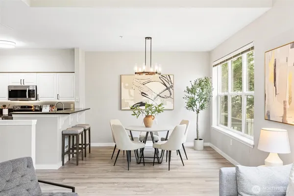 a dining room with furniture a window and wooden floor