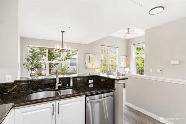 a kitchen with granite countertop a sink and a window