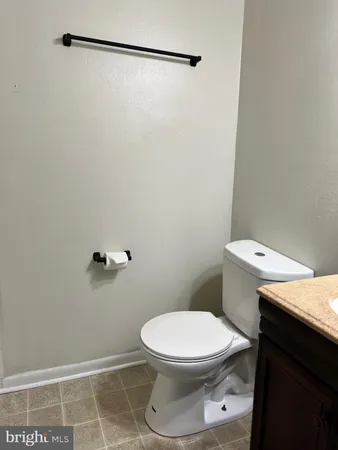 a white toilet sitting next to a shower