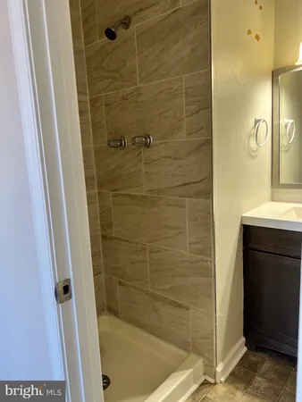 a bathroom with a shower and a sink