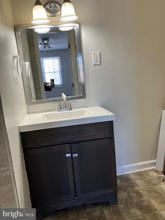 an empty room with window and bathroom