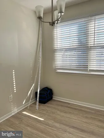 a view of a livingroom with an empty space and a window