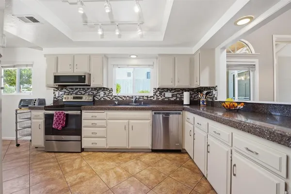 a kitchen with stainless steel appliances granite countertop a stove sink and cabinets