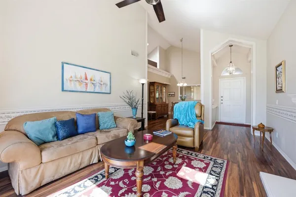 a living room with furniture and wooden floor