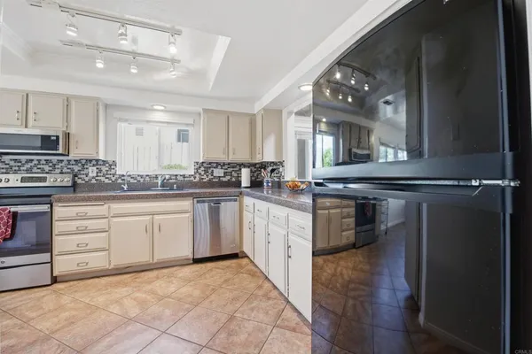 a kitchen with granite countertop a sink stove and cabinets