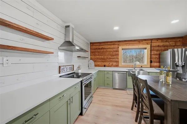 a kitchen with a table and chairs in it