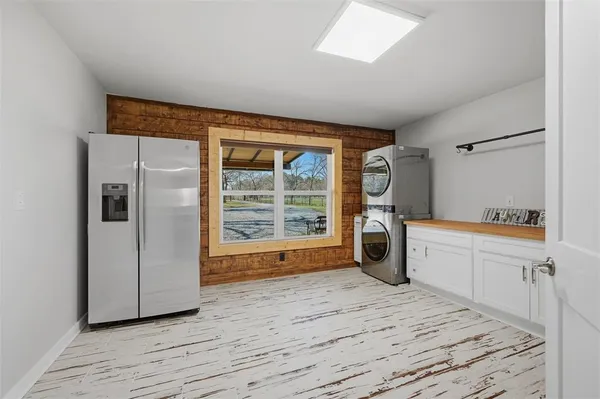 a kitchen with granite countertop a stove a sink a dining table and chairs