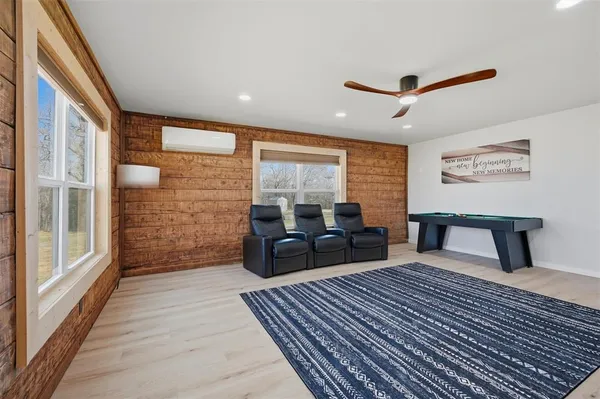 a kitchen with a refrigerator and wooden floor