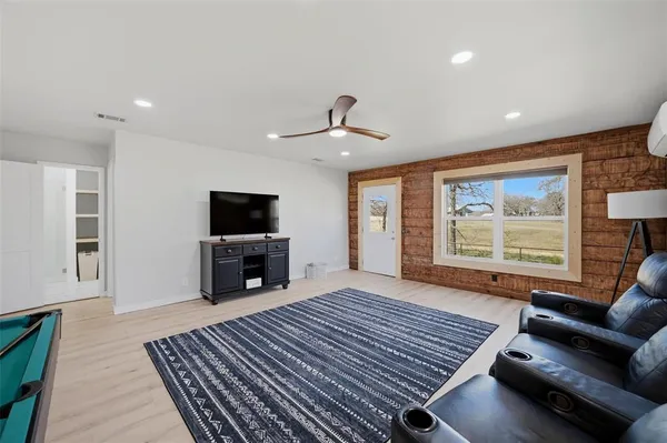 a bedroom with furniture and large window