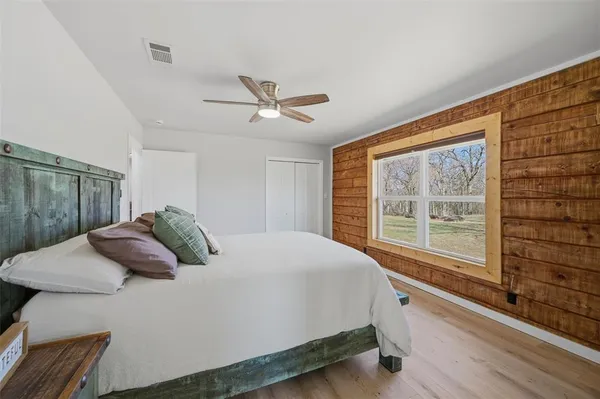 a bedroom with a large bed and a large window