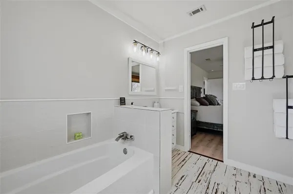a bedroom with a large bed and a large window