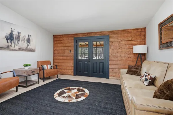 a living room with furniture and wooden floor