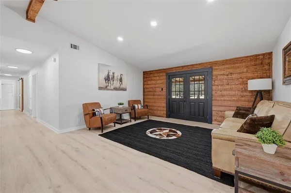 a living room with furniture rug and window