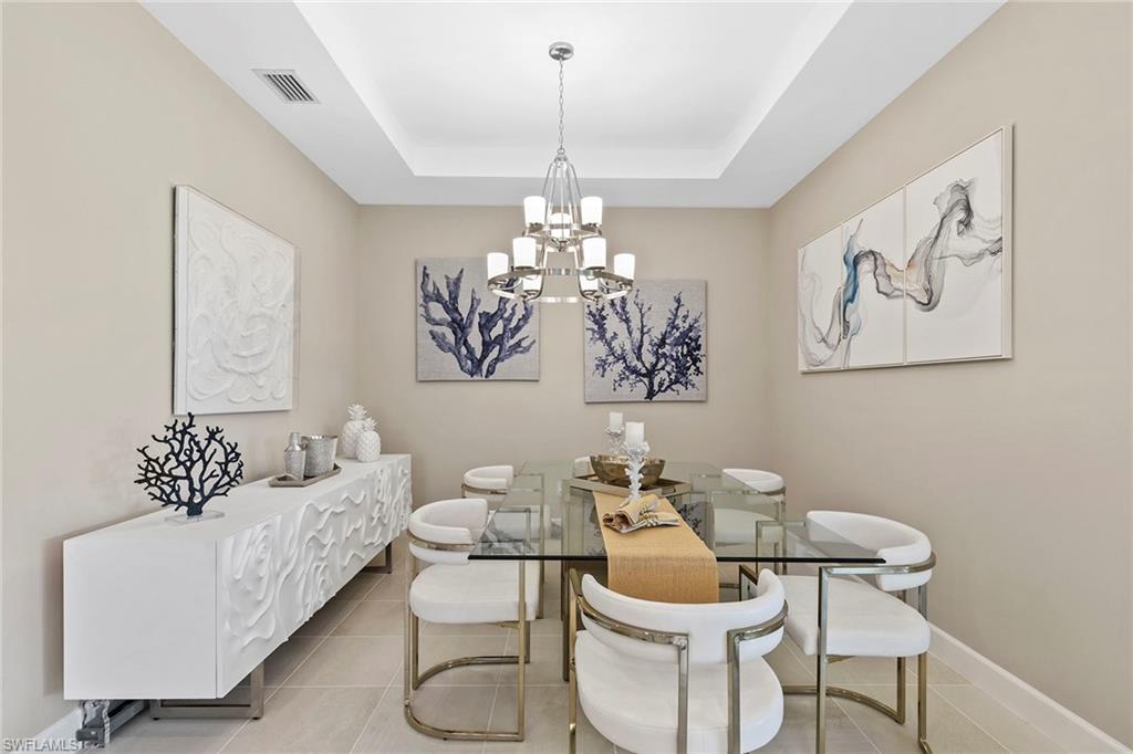 15189 Sacile Court Naples, FL 34114 - Photo 13 of 30 a living room with furniture and a chandelier