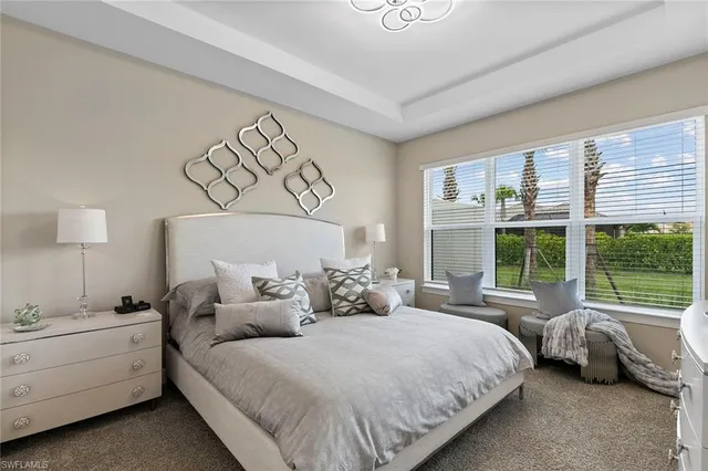 a bed room with a bed and a large window