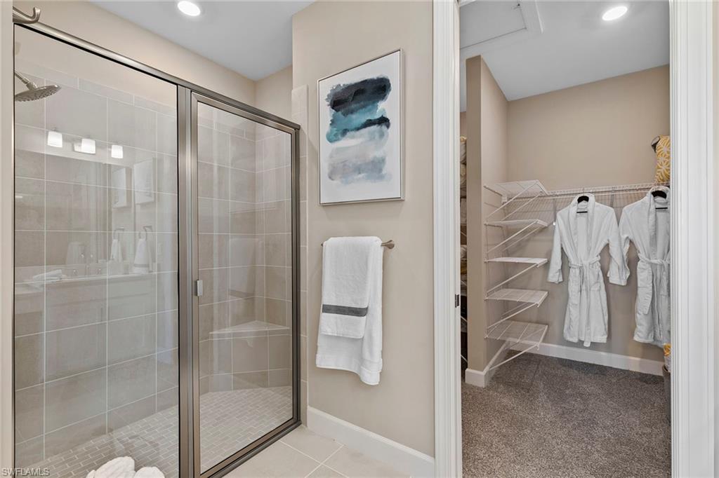 15189 Sacile Court Naples, FL 34114 - Photo 17 of 30 a view of walk in closet and bathroom