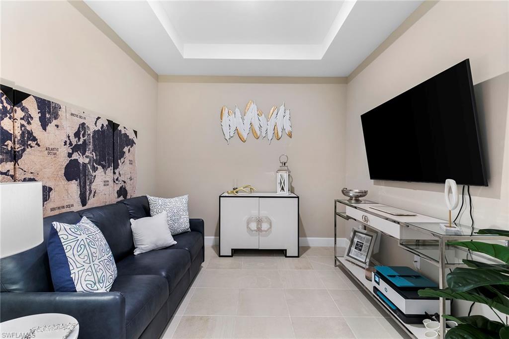 15189 Sacile Court Naples, FL 34114 - Photo 19 of 30 a living room with furniture and a flat screen tv