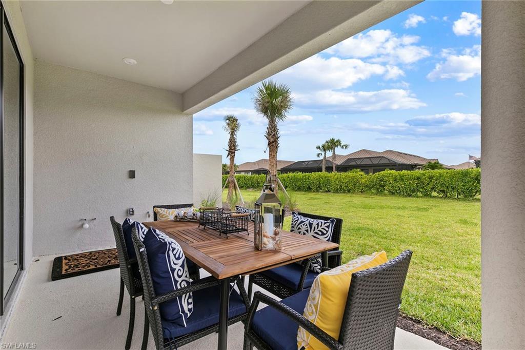15189 Sacile Court Naples, FL 34114 - Photo 25 of 30 a view of an outside dining space with furniture